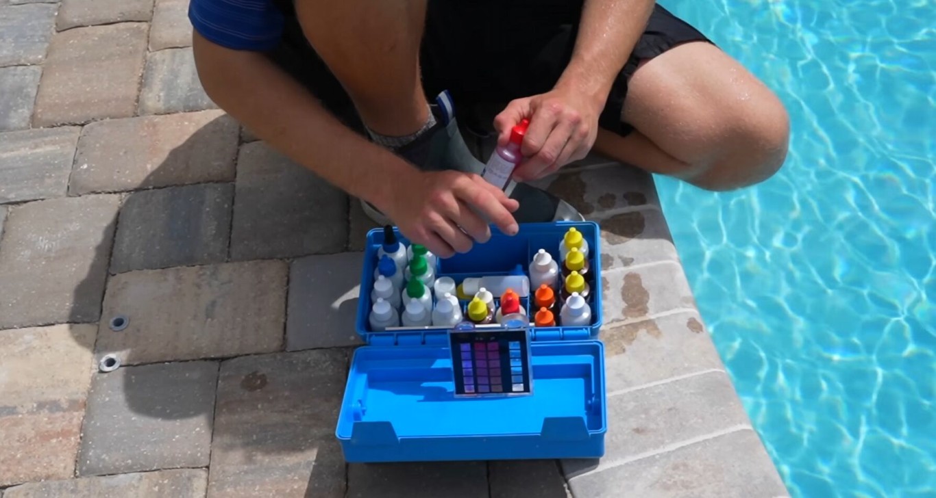 Professional pool technician testing water chemistry